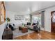 Bright living room featuring hardwood floors, a large window, and stylish decor at 7839 Florado St, Denver, CO 80221