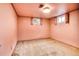 Room with pink walls, carpeted floors, and two shuttered windows at 7839 Florado St, Denver, CO 80221