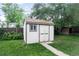 Charming backyard shed with painted siding and a shingle roof, offering extra storage space at 7839 Florado St, Denver, CO 80221
