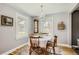 Bright dining room with hardwood floors, large windows, and a chandelier above table at 1629 Valentia St, Denver, CO 80220
