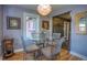 Bright dining area features hardwood floors, natural light, and view into living room at 1629 Valentia St, Denver, CO 80220