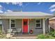 Inviting front porch with red door, potted plants and chairs, providing a welcoming entrance at 1629 Valentia St, Denver, CO 80220