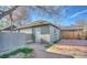 Detached garage with a white door, a brick walkway, and a small yard at 1629 Valentia St, Denver, CO 80220