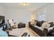 Comfortable living room with a leather sofa, rocking chair, and soft lighting at 1629 Valentia St, Denver, CO 80220