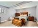Cozy bedroom features neutral tones, a wooden bed set, and soft carpet at 1629 Valentia St, Denver, CO 80220