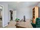Home office with a wooden desk, shelving, and a view into a hallway at 1629 Valentia St, Denver, CO 80220