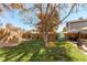 A well-maintained backyard with a lush lawn, wooden fence, and patio area at 9310 Pierce St, Broomfield, CO 80021