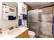 Bathroom featuring a vanity with sink, toilet, and sliding glass shower with bronze hardware at 9310 Pierce St, Broomfield, CO 80021