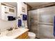 Bathroom featuring a vanity with sink, toilet, and sliding glass shower with bronze hardware at 9310 Pierce St, Broomfield, CO 80021
