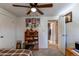 Bedroom view featuring a bookshelf, closet and doorway to the bathroom with warm natural light at 9310 Pierce St, Broomfield, CO 80021