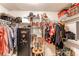 Walk-in closet with shelving, hanging racks, hats, clothing, cowboy boots, gun safe, and other storage items at 9310 Pierce St, Broomfield, CO 80021