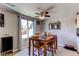 Cozy dining area with wood table, ceiling fan, and a window offering natural light at 9310 Pierce St, Broomfield, CO 80021