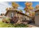 Single-story home with green lawn, privacy fence, and detached garage at 9310 Pierce St, Broomfield, CO 80021