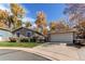 A single-story home with a detached two-car garage and a well-kept front lawn at 9310 Pierce St, Broomfield, CO 80021