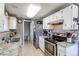 Well-equipped kitchen featuring white cabinets, stainless steel appliances, and neutral countertops at 9310 Pierce St, Broomfield, CO 80021