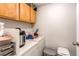 Laundry room with washer, dryer, cabinets, and supplies at 9310 Pierce St, Broomfield, CO 80021