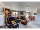 Spacious living room with large windows, comfortable seating, and an adjacent dining area at 9310 Pierce St, Broomfield, CO 80021