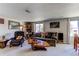 Open-concept living room featuring comfortable seating and large windows for natural light at 9310 Pierce St, Broomfield, CO 80021