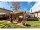The backyard of this home features a patio with umbrella-covered seating and mature landscaping at 9310 Pierce St, Broomfield, CO 80021