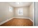 Comfortable bedroom with hardwood floors, a ceiling fan, and a well-lit window at 2345 S Williams St, Denver, CO 80210