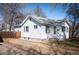 Charming home exterior with white siding, inviting entry, and driveway at 2345 S Williams St, Denver, CO 80210