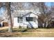 Traditional-style home with a bright white exterior complemented by dark shutters and surrounded by mature trees at 2345 S Williams St, Denver, CO 80210