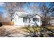 Charming single-story home featuring a clean white exterior with black shutters and a well-maintained front yard at 2345 S Williams St, Denver, CO 80210