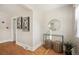 Inviting entryway featuring modern art, a round mirror, and decorative wicker stools at 2345 S Williams St, Denver, CO 80210