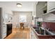 The kitchen has stainless steel sink, tiled backsplash, and white cabinets at 2345 S Williams St, Denver, CO 80210