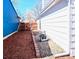 View of the backyard with wood-chip ground cover and gravel running along the side of the house at 17968 E Colgate Pl, Aurora, CO 80013