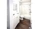 Modern bathroom with white tiled shower, vanity with storage, and updated fixtures at 17968 E Colgate Pl, Aurora, CO 80013