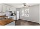 Well-lit kitchen featuring white cabinets, wood-look countertops, and modern appliances at 17968 E Colgate Pl, Aurora, CO 80013
