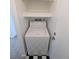 Convenient laundry area featuring a washing machine and overhead shelving for storage solutions at 17968 E Colgate Pl, Aurora, CO 80013
