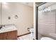 Bathroom with granite countertop, wood vanity, and glass-enclosed shower with seat at 1376 S Laredo Ct, Aurora, CO 80017