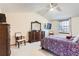 Bright bedroom features vaulted ceiling, ceiling fan, large dresser, and a cozy window seat at 1376 S Laredo Ct, Aurora, CO 80017