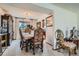 Traditional dining room with chandelier, floral accents, and plush upholstered chairs near a large window at 1376 S Laredo Ct, Aurora, CO 80017
