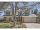 Charming two-story home features a covered front porch, brick accents, and mature landscaping at 1376 S Laredo Ct, Aurora, CO 80017