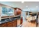 Well-lit kitchen featuring granite countertops, stainless steel appliances, and hardwood floors at 1376 S Laredo Ct, Aurora, CO 80017