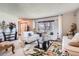Bright living room featuring white sofas, a glass coffee table, a floral rug, and a view to the entry at 1376 S Laredo Ct, Aurora, CO 80017