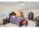 Inviting main bedroom with a bed, bench seating, dresser, and an ensuite bathroom at 1376 S Laredo Ct, Aurora, CO 80017