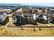 New homes with modern exteriors line a neighborhood street, set against a backdrop of rolling mountains at 8816 Whiteclover St, Littleton, CO 80125