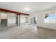 Unfinished basement with concrete floors, large windows, offering plenty of natural light and potential at 8816 Whiteclover St, Littleton, CO 80125