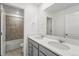 Well-lit bathroom boasting a double vanity with modern fixtures and a separate tiled tub/shower combo at 8816 Whiteclover St, Littleton, CO 80125