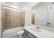 Bathroom with tiled shower/bath combo, grey vanity, and white countertop at 8816 Whiteclover St, Littleton, CO 80125