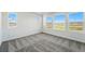 Bright and airy bedroom with plush carpeting and multiple windows with scenic views at 8816 Whiteclover St, Littleton, CO 80125