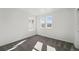 Sunny bedroom with neutral carpeting and two large windows offering scenic neighborhood views at 8816 Whiteclover St, Littleton, CO 80125