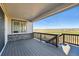 Back deck featuring wood railing, stone facade, and expansive views of the surrounding landscape at 8816 Whiteclover St, Littleton, CO 80125