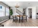 Elegant dining room with a stylish table, modern lighting fixture, and views of the staircase at 8816 Whiteclover St, Littleton, CO 80125