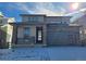Charming two-story home featuring stone accents, a covered porch, and an attached garage at 8816 Whiteclover St, Littleton, CO 80125