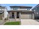 Charming two-story home with stone accents and a well-maintained front yard and modern garage at 8816 Whiteclover St, Littleton, CO 80125